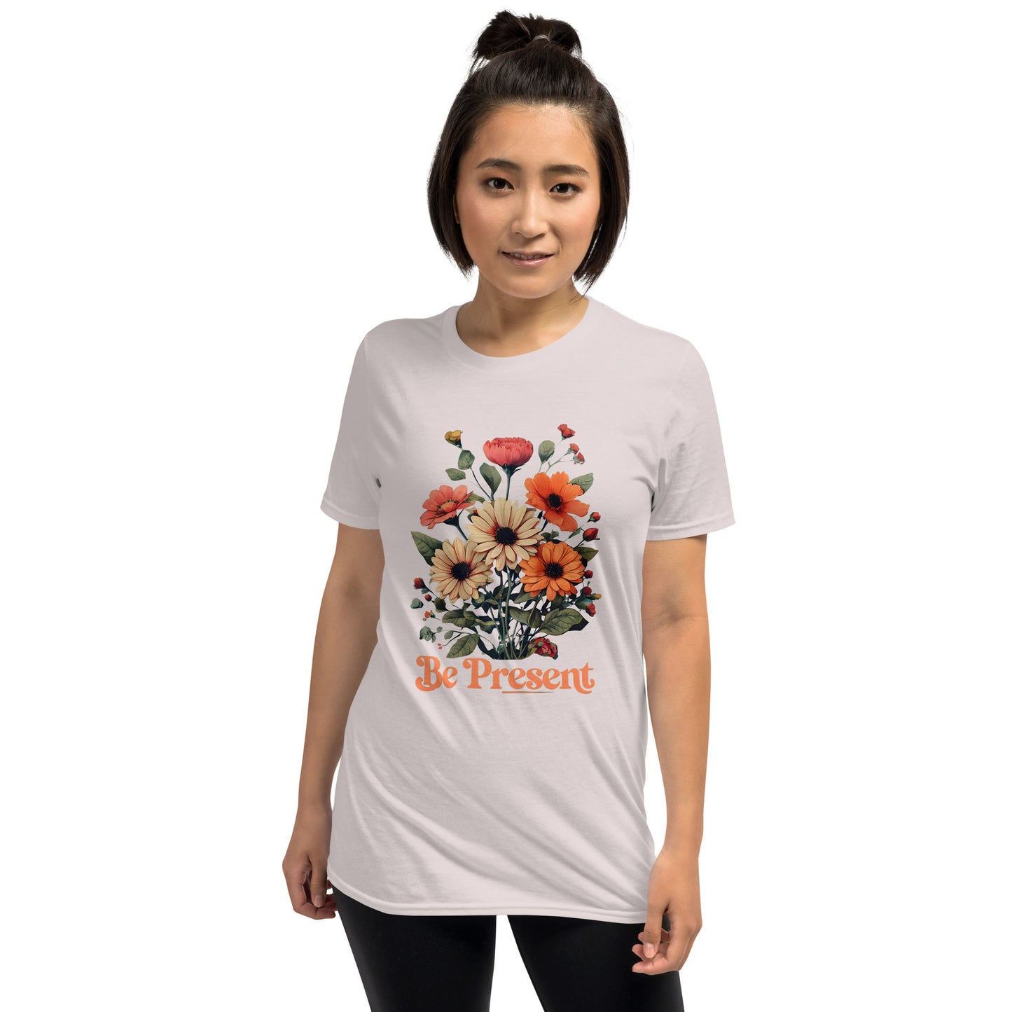 Person wearing a grey t-shirt with floral design and 'Be Present' text on a white background