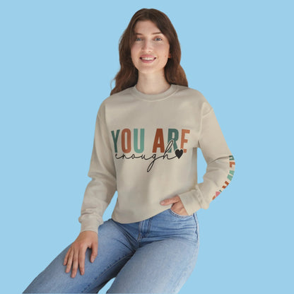 Woman wearing  tan you are enough always sweatshirt