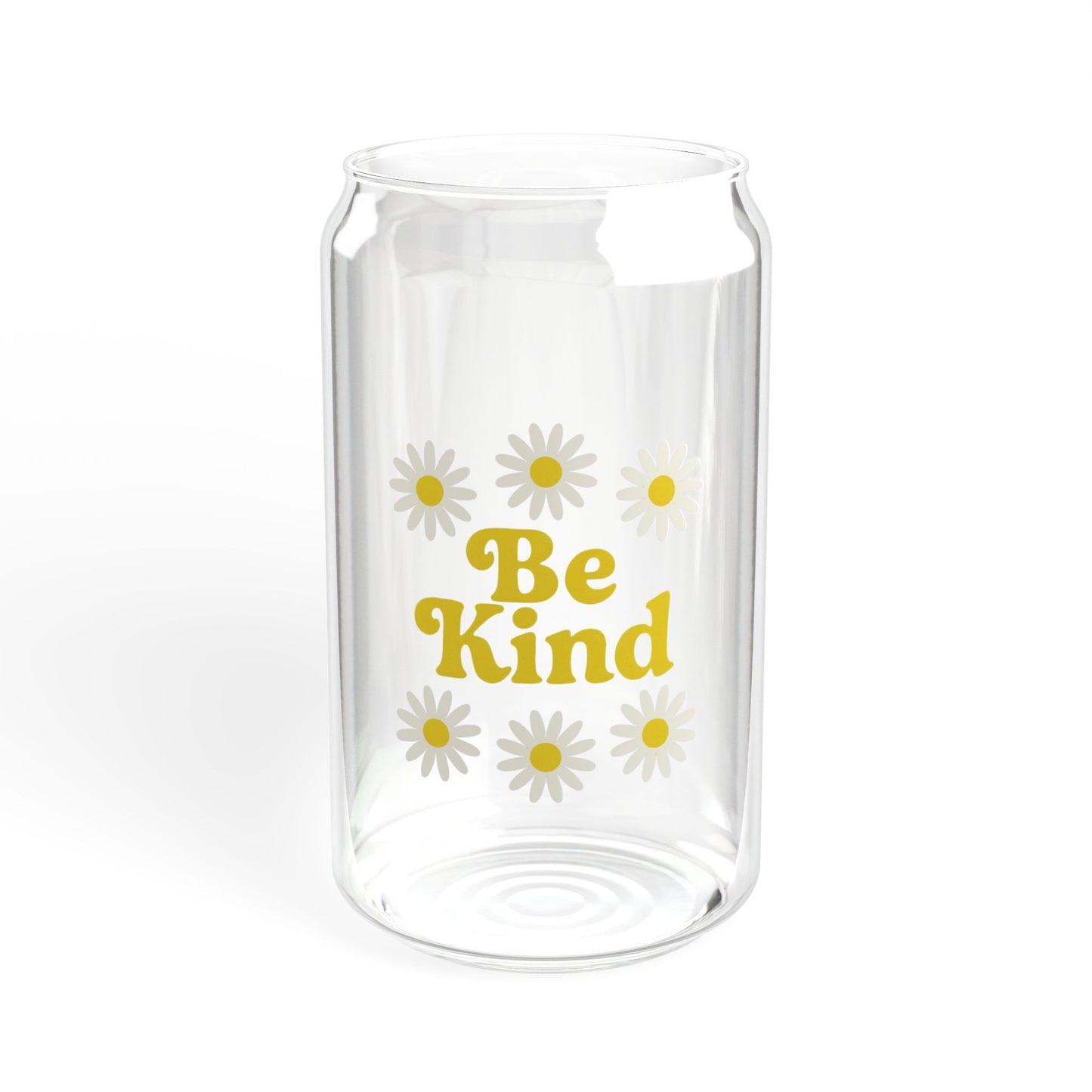 Clear glass vase with 'Be Kind' text and daisy flowers on a white background