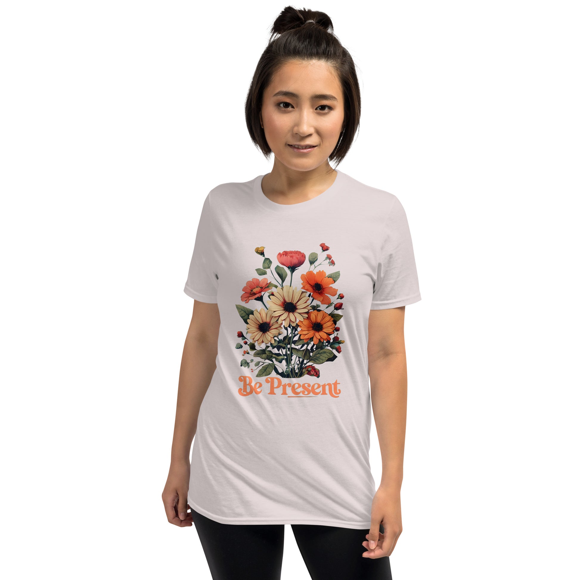 Person wearing a grey t-shirt with floral design and 'Be Present' text on a white background