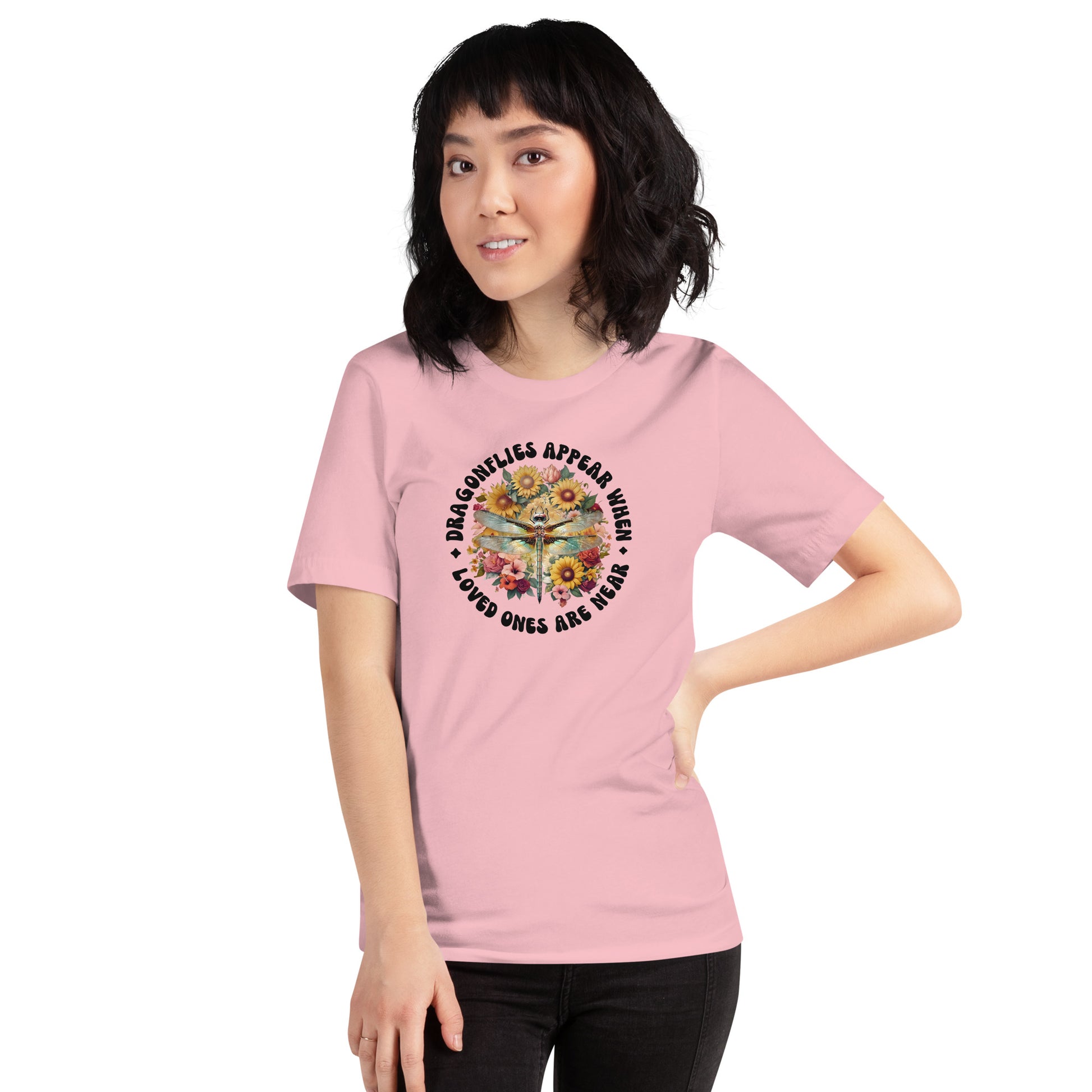 Person wearing a pink t-shirt with a graphic design and text on a white background